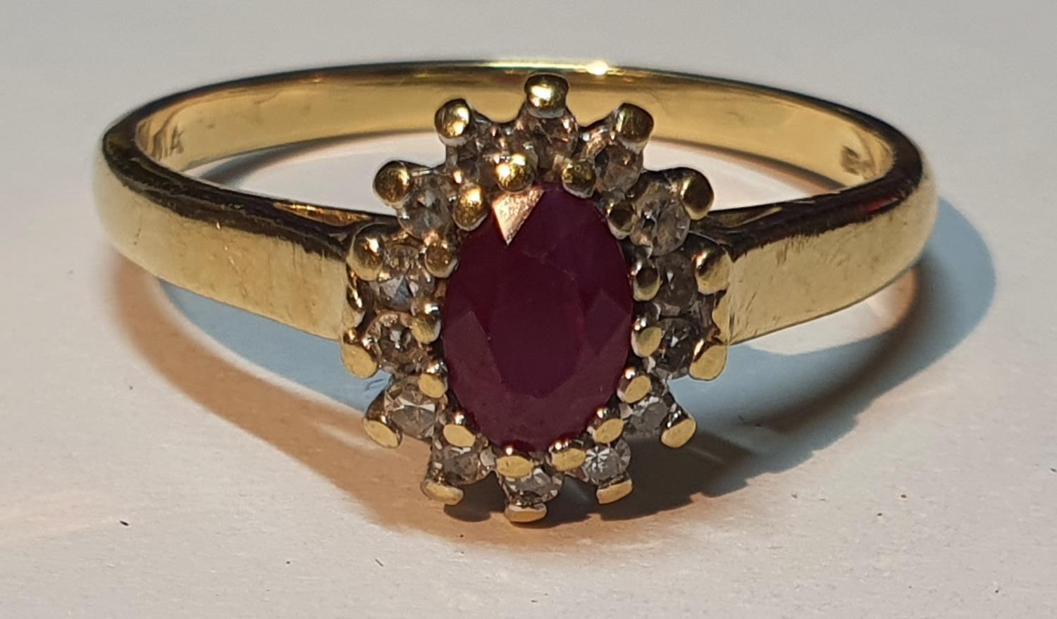An 18ct gold ruby and diamond cluster ring. Estimated total diamond weight 0.15ct. Hallmarks for - Image 3 of 4