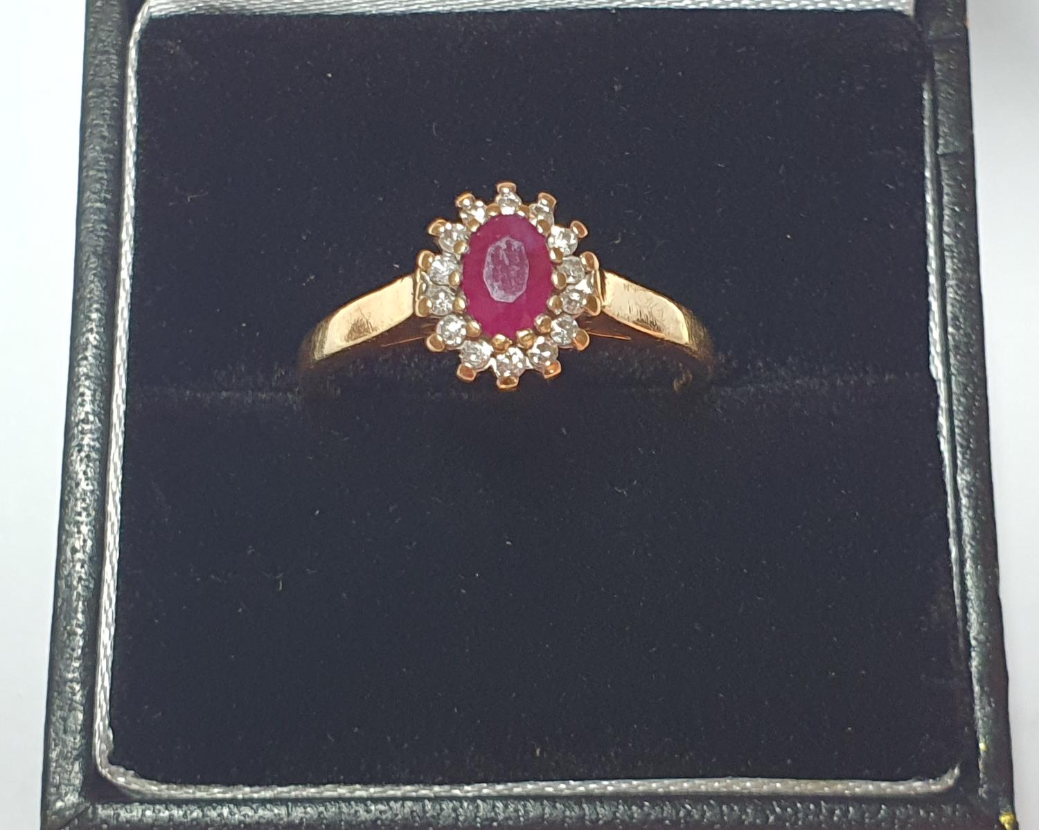 An 18ct gold ruby and diamond cluster ring. Estimated total diamond weight 0.15ct. Hallmarks for - Image 4 of 4