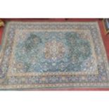 A green ground Rug with multi borders and all over design. 160 x 228 cms approx.
