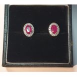 A pair of 18ct gold ruby and diamond earrings. Total ruby weight 1.24cts. Total diamond weight 0.