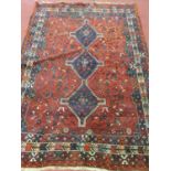 A good burgundy ground Rug. 243 cm x 171 cm approx. (slight damage to one corner).