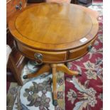 A modern Mahogany miniature Drum Table with toe castors and timber top.