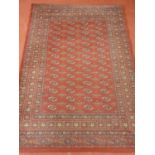 A good burgundy ground Rug with multi borders and repeating pattern. 160 x 228 cm approx.