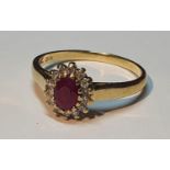 An 18ct gold ruby and diamond cluster ring. Estimated total diamond weight 0.15ct. Hallmarks for