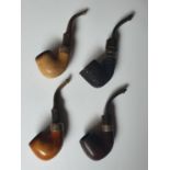 A group of four Petersons of Dublin Pipes with Silver ferrules.