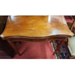 Of Superb quality, A Regency Mahogany Serpentine fronted Foldover Card Table on square tapered
