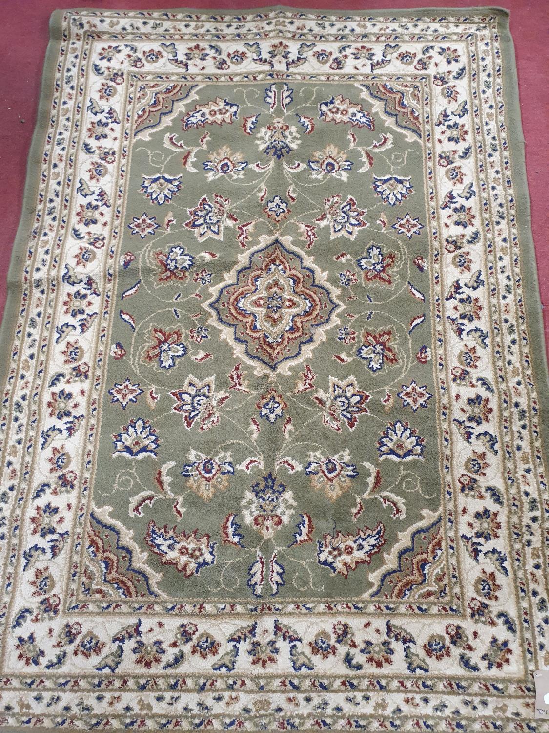 A green ground Rug. 120 x 170 cm approx.