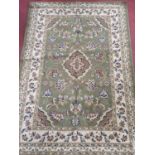 A green ground Rug. 120 x 170 cm approx.