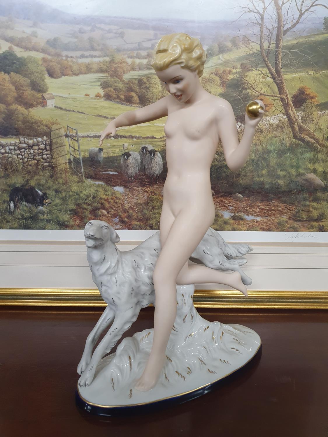 A large Royal Dux Art Deco-style tinted Bisque and glazed Figure of Female nude throwing a ball