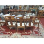 A good Hardwood two leaf Dining Table with a set of eight Chairs.