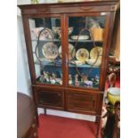 An Edwardian astragal glazed Mahogany Display Cabinet with cupboard under, raised on squared