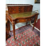 A modern Mahogany and Veneered Desk with leather insert, twin frieze drawers, serpentine front and
