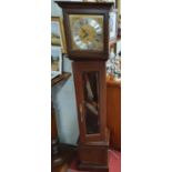A Mahogany cased Grandmother Clock with eight day movement with Westminster chimes, the square brass