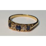 An 18ct gold sapphire and old-cut diamond five-stone ring. Estimated total diamond weight 0.20ct,