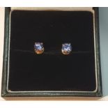 A pair of tanzanite stud earrings. Stamped 14K.Diameter 0.4cm.