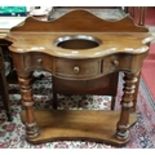 A good 19th Century Serpentine fronted Washstand with turned and fluted supports on a platform base.