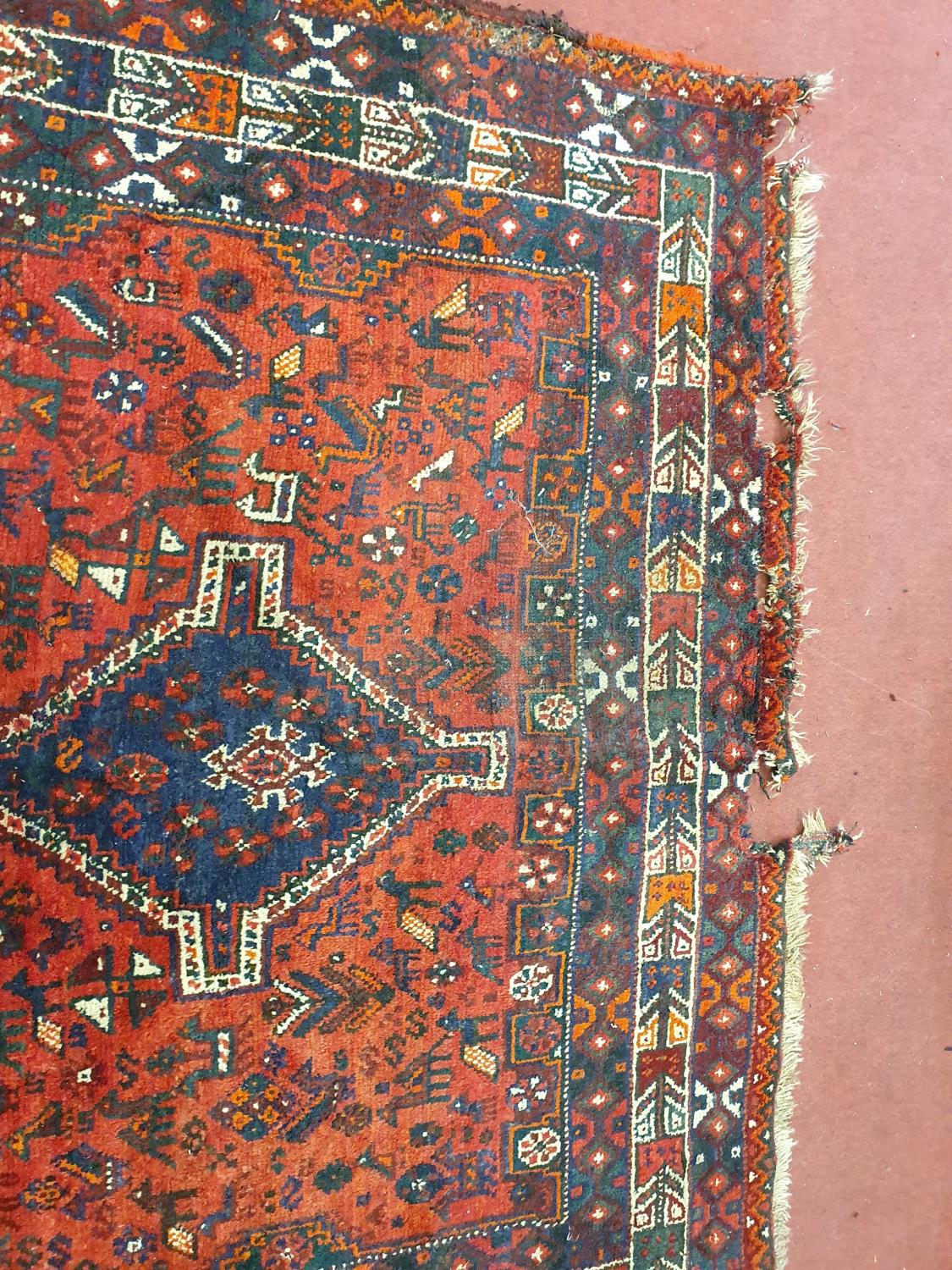 A good burgundy ground Rug. 243 cm x 171 cm approx. (slight damage to one corner). - Image 2 of 2