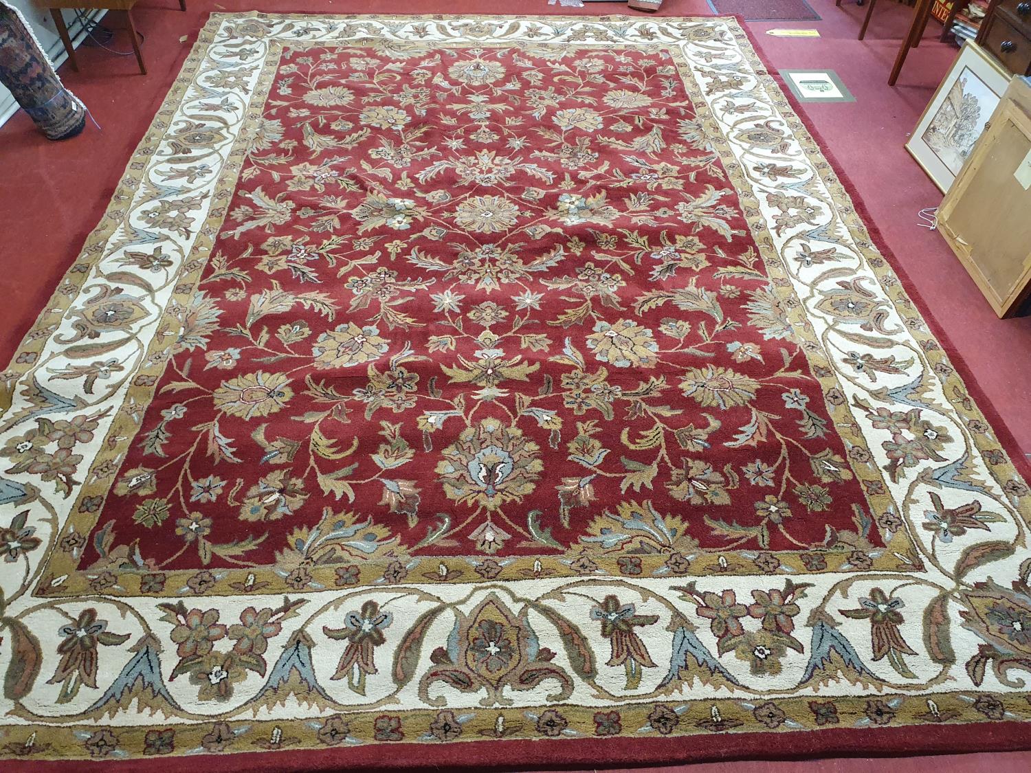 A large red ground Carpet with unique design and multi borders. 297 x 415 cm approx.