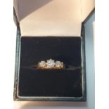 An 18ct gold brilliant-cut diamond three-stone ring. Estimated total diamond weight 0.50ct, H-I