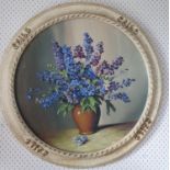A 20th Century Oil on Board of Delphiniums in its original circular frame, Signed LR. Diam. 51cm