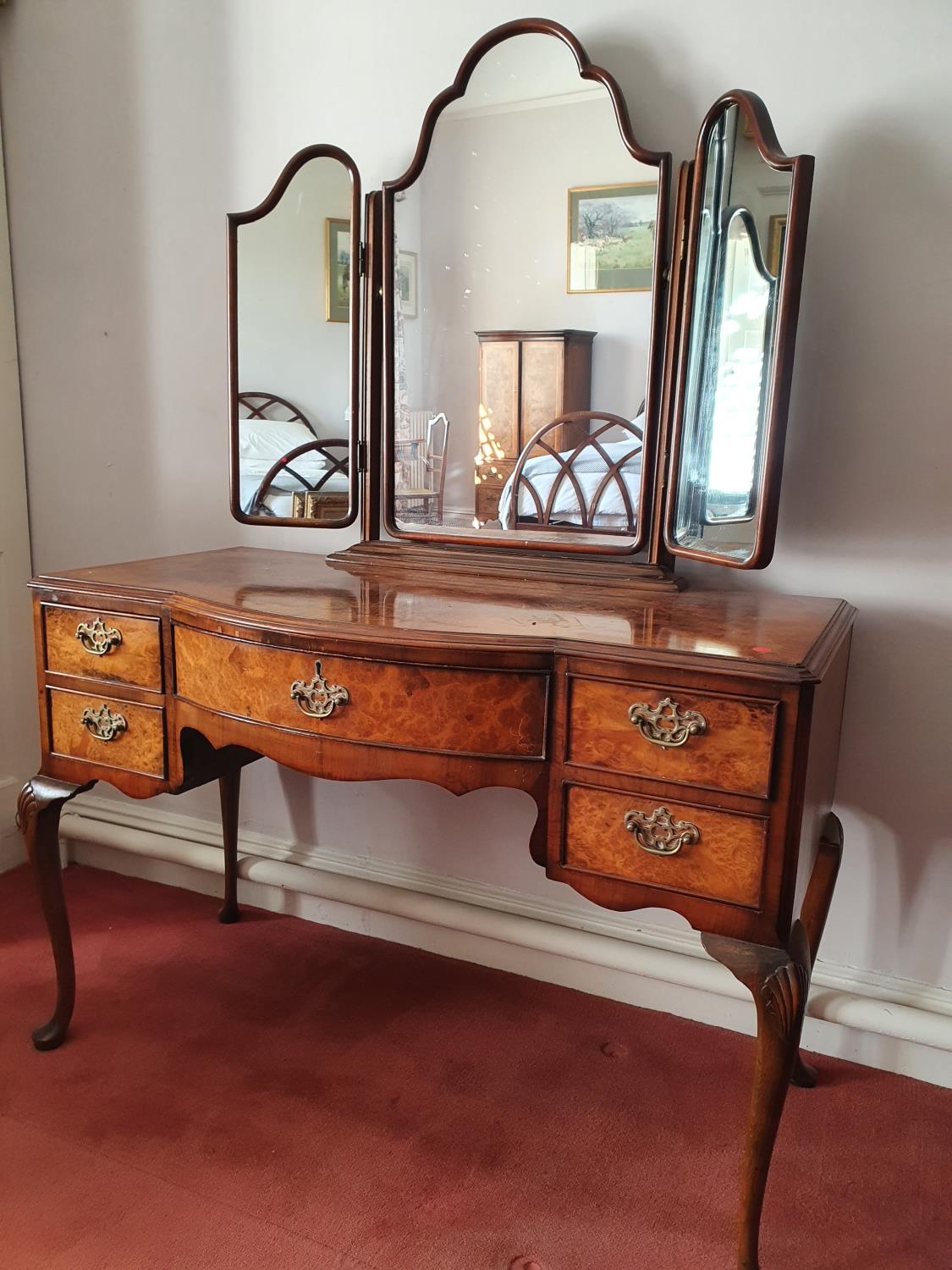 A 20th Century Walnut Dressing Table with triptych mirrored back on carved cabriole supports. H158 x