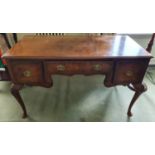 A late 19th early 20th Century Walnut Dressing Table with a three drawer front on carved cabriole