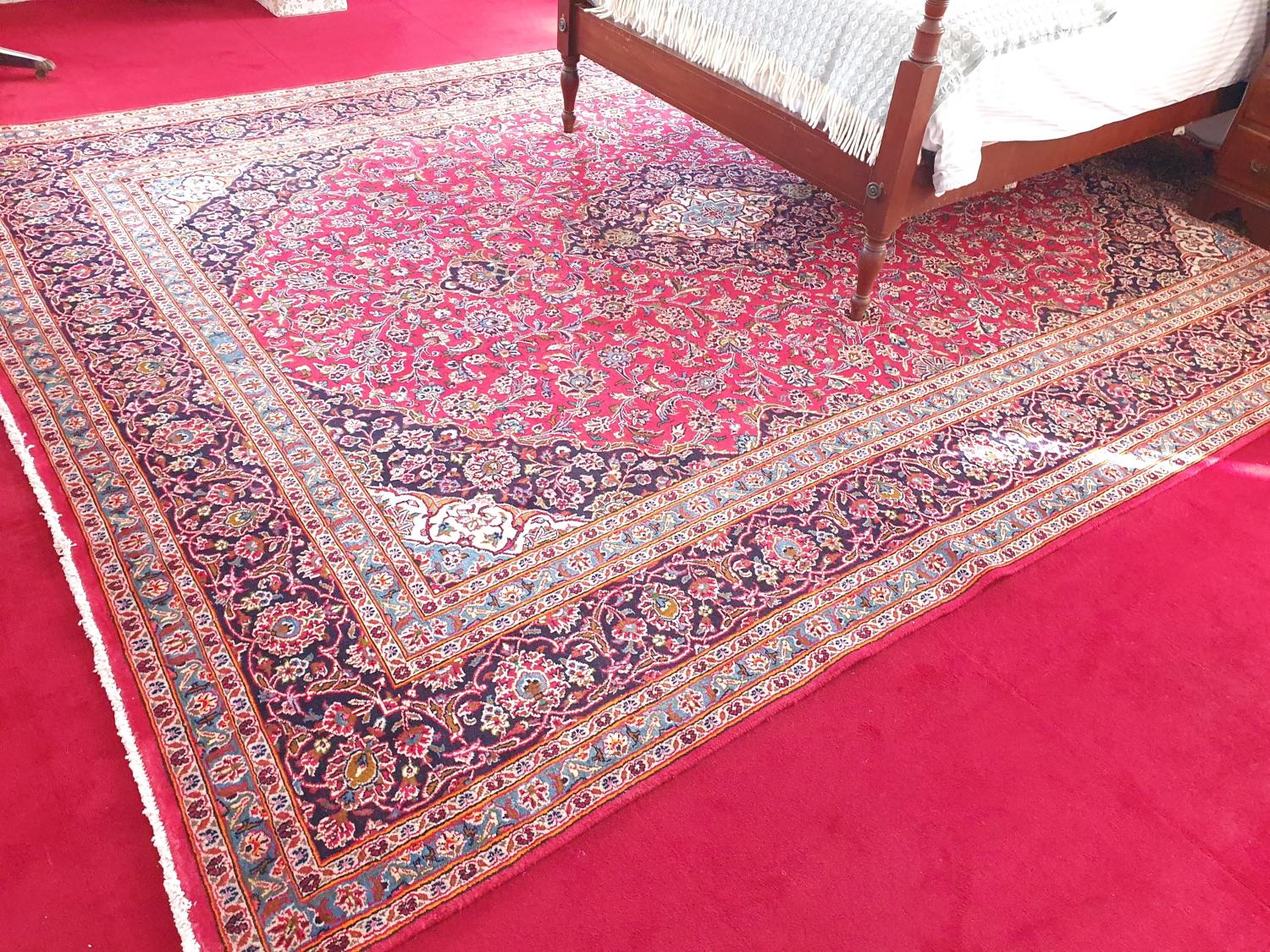 A Persian red ground carpet with unique all over design and multi borders. 395 x295cm approx.
