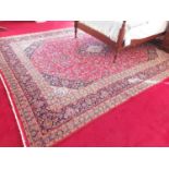 A Persian red ground carpet with unique all over design and multi borders. 395 x295cm approx.