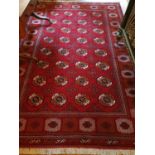 A Rich red ground full pile hand woven Turkmen double knot Carpet in traditional Bokhara allover