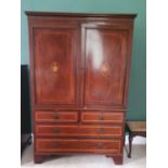 A Regency Mahogany Inlaid Gentleman's Wardrobe with Urn detail, panelled doors, two short over two