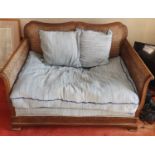 An early 20th Century Bergere two seater Couch with fretwork style front. H78 x D60 x W115cm approx.