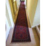 A large Terracotta ground very fine handwoven Indian Runner with traditional floral medallion design