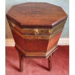 A good Georgian Mahogany octagonal Brass bound Wine Cooler on square supports with brass castors and