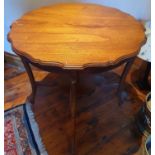 An Edwardian Mahogany Centre Table with serpentine outline top and stretcher base. H75 x W76cm