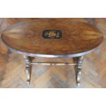 A Victorian Walnut and veneered oval Center Table on stretcher base.