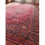 A very large red ground Persian Marshad Carpet with unique all over floral design and multi borders.