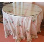 A circular Glass topped Table with fabric top. Diam.76 x 71cm approx.