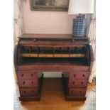 A 19th Century Mahogany Cylinder Pedestal Desk with fully fitted interior and pull slide writing