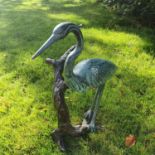 A fabulous Bronze Crane standing on a branch.