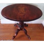 A late 19th early 20th Century oval Walnut Side Table with drop leaves on a turned carved base,