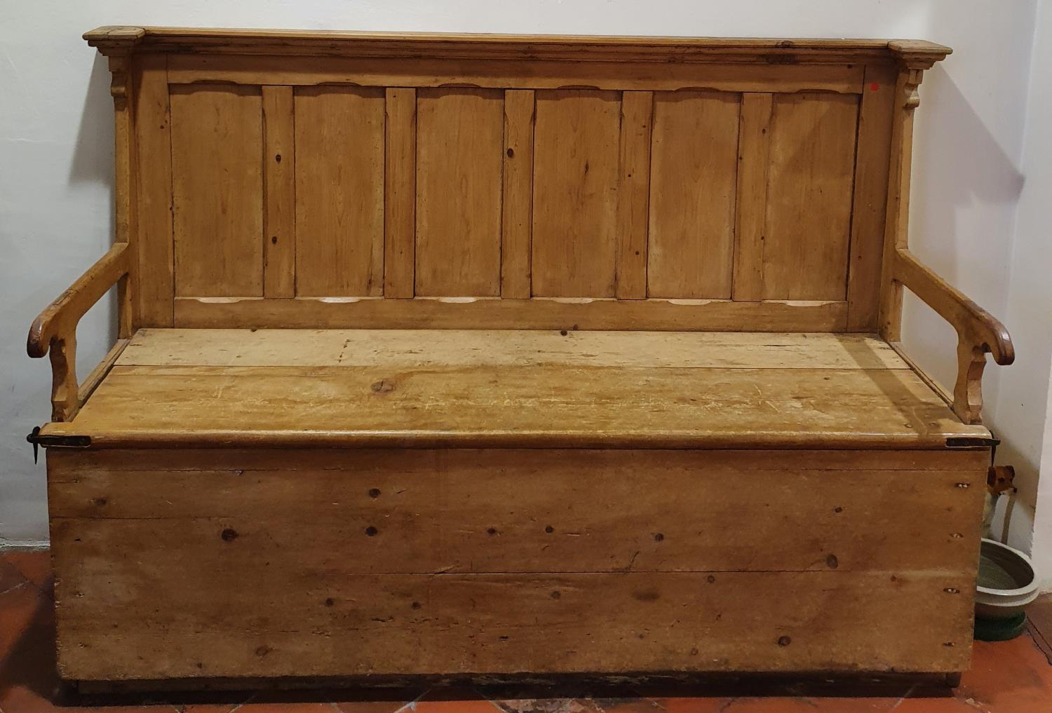 A very large 19th Century stamped Pine Settle with lift up seat and panelled back H129 x D63 x