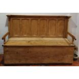 A very large 19th Century stamped Pine Settle with lift up seat and panelled back H129 x D63 x