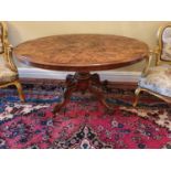 A really good Victorian Walnut Inlaid oval Centre Table with a carved pod and floral inlaid top. H74