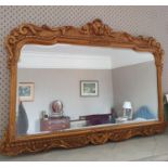 A late 19th Century Gilt Over mantle Mirror, with a highly decorated surround. H65 x W90cm approx.