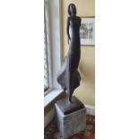 A Fabulous modern Bronze of a Female with a free flowing dress on a plinth stand.