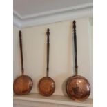 Three Copper Warming Pans. H109 x D9 x W32cm approx.