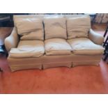 A 19th Century three seater Couch in the style of Howard & Sons. With beige upholstery. H85 x D72