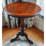 A 19th Century Walnut Crossbanded Circular Wine Table with a highly carved fluted tripod base and
