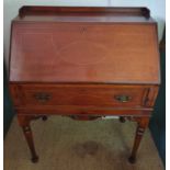 A late 19th Century Mahogany and inlaid Bureau on turned supports.