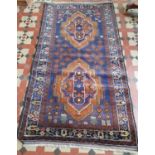 An Afghan Baluchi Nomadic Rug with blue ground and double medallion design. 195 x 111 cms approx.